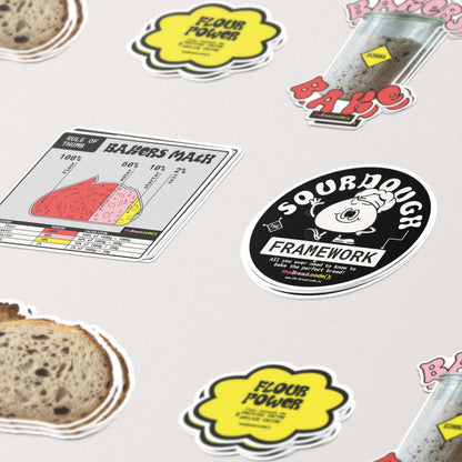 Close-up of the Wild & Yeasty sourdough stickers — loaf, "Bakers Babe" and Sourdough Framework badge